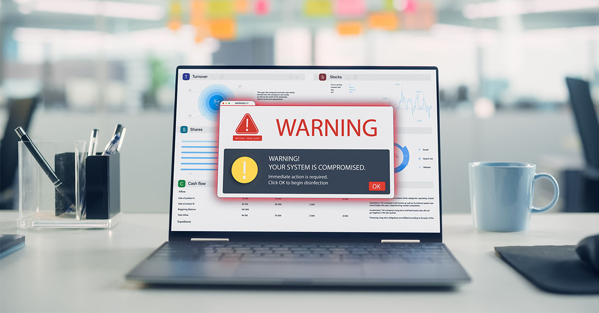 Laptop displaying a cybersecurity warning about a compromised system, illustrating ransomware and data breach risks for startups.