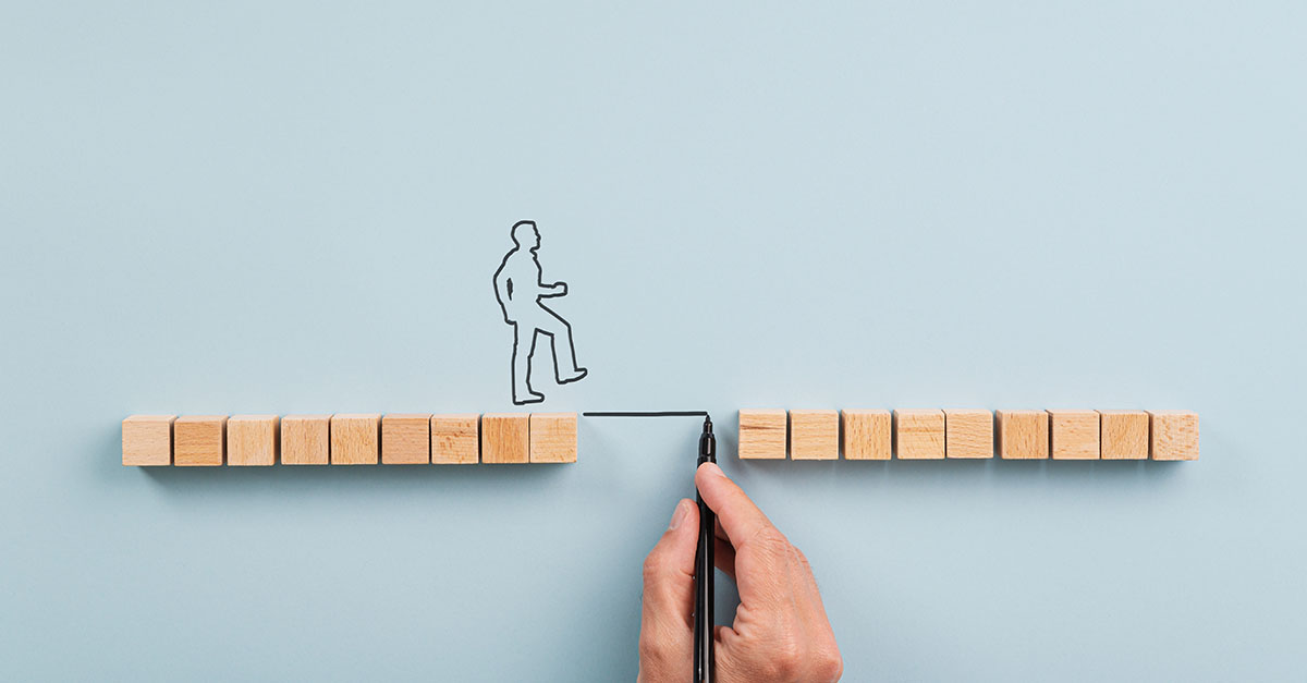 Illustration of a person stepping across a gap between wooden blocks, representing SOC 2 audit readiness and identifying control gaps.